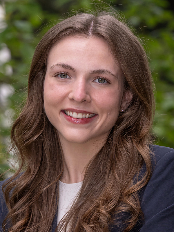 Close-up of Elizabeth Holmes wearing a blue blazer and white top.