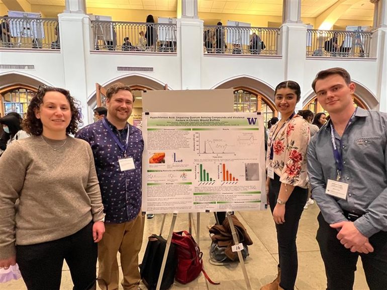 The team that presented Hypochlorous Acid: Impairing Quorum Sensing Compounds and Virulence Factors in Chronic Wound Biofilms. Dr. Lori Robins, the team's mentor, is on the left.