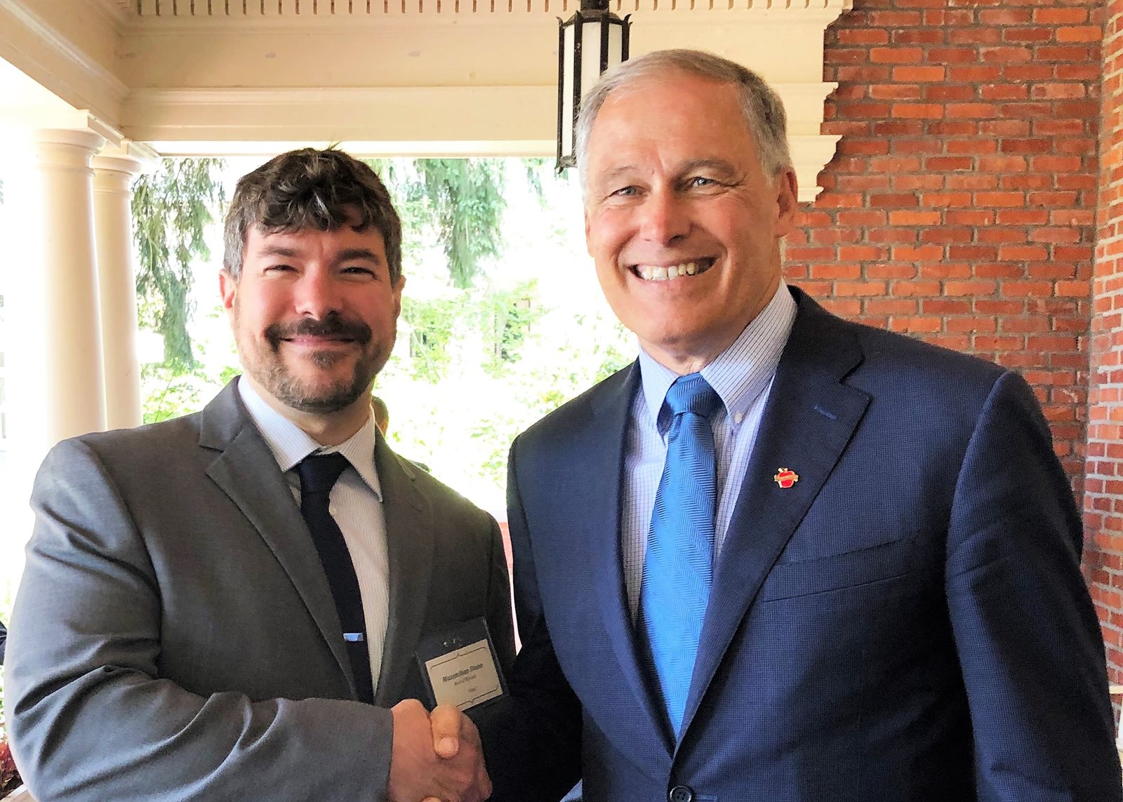 Maximilian Dixon, left, Gov. Jay Inslee