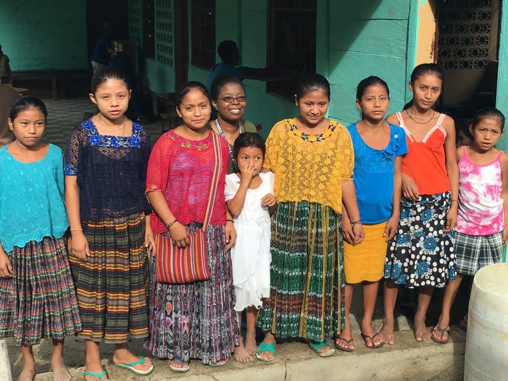 Team Leader with Children at Clinic