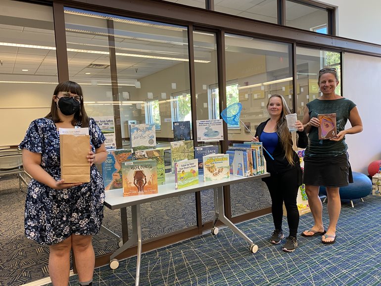 Emily (l) with Nicole Reiber and Dr. Avery Shinneman at the Libraries Love Lakes event