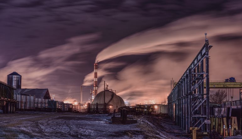 Industrial pollution darkens sky.