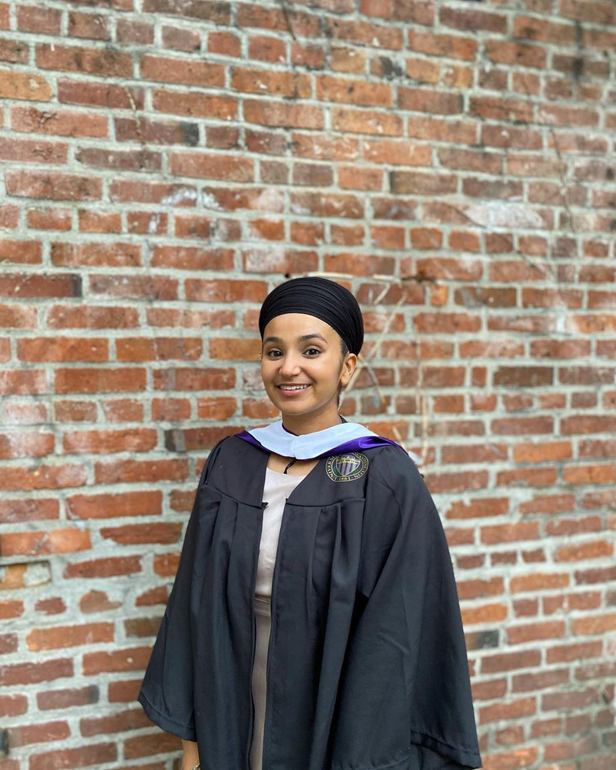 Sharndeep Shoker smiling in graduation regalia