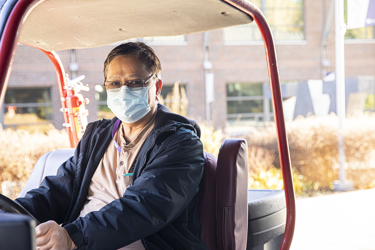 Angelo driving a facilities cart