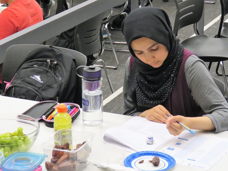 Zoha Awan taking test at night.